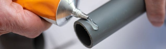 applying glue on pvc pipe
